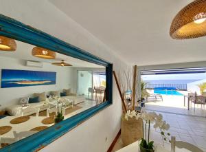a living room with a view of the ocean at FRONTLINE VILLA 26, Modern Coastal Design with Amazing Views in Puerto Calero
