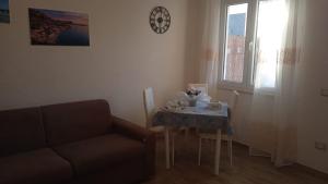 a living room with a table and a couch at Casa Rosa Forio d'Ischia in Forio d'Ischia