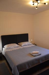 a bedroom with a bed with two towels on it at Apartman Željko in Zadar