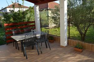 a patio with a table and chairs on it at Apartman Željko in Zadar