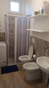 a bathroom with a toilet and a sink and a shower at Casa Rosa Forio d'Ischia in Forio d'Ischia