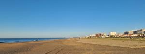 a view of a beach with buildings in the background at Piso de 3 habitaciones en el centro de Punta Umbria recién renovado! in Punta Umbría