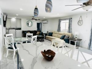 a living room with a couch and a table at Caribbean Breeze- 4 Bedroom- 4 ensuite bathrooms in Oranjestad