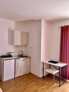 a kitchen with a table and a small table with a table at Apartments Nautilus in Ulcinj