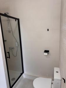 a bathroom with a toilet and a glass shower at l espérandieu in Marseille