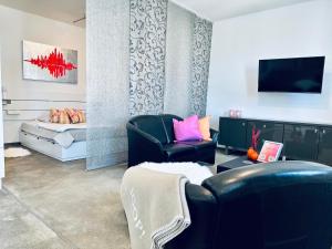 a living room with a couch and a tv at Stylish & central #LoftWerk 2 in Velbert