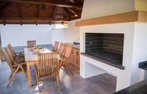 a kitchen with a dining table and a fireplace at Villa Old Hills by Villas Guide in Ljubešćica