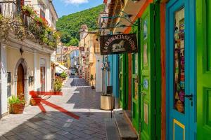a narrow street with colorful buildings in a city at La Casa in Piazza in Maratea
