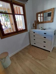 a bedroom with a dresser and a mirror at Casa de Mar in Barrio-Mar