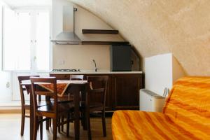 a kitchen and dining room with a table and chairs at Residence Del Casalnuovo in Matera +76 photos