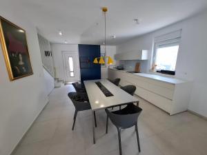 a kitchen and dining room with a table and chairs at Casa Bučina in Umag