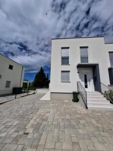 a white house with a brick driveway at Casa Bučina in Umag