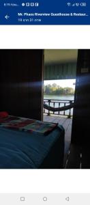 a picture of a bed with a view of the water at MrPhaos Riverview in Don Det