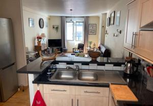a kitchen with a sink and a counter top at Appartement Granville hyper centre in Granville +9 photos