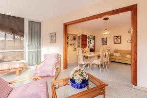 a living room with a table and a dining room at VV Lorca Beach Puerto Naos in Puerto Naos