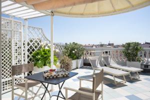 a patio with a table and chairs on a balcony at Palace Hotel in Viareggio