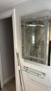 a bathroom with a glass shelf and a mirror at Abena' Villa in Moffat