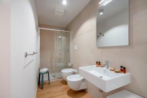 a bathroom with a white sink and a toilet at Sogno di Mare in Bari +12 photos