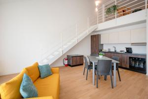a living room with a yellow couch and a table at Sogno di Mare in Bari