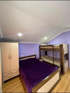 a bedroom with two bunk beds and purple walls at GB cottages Bakuriani in Bakuriani