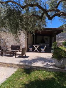 a patio with two chairs and a table and a bench at Villa Ponta in Buljarica +12 photos