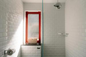 a bathroom with a red window and a shower at Cabin at Mackay's in Durness