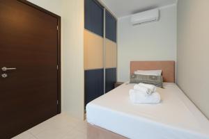a small bedroom with a bed with towels on it at Serenity Retreat Villa by IdealStay Experience in Heraklio Town