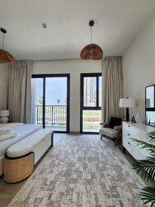 Un dormitorio con una cama grande y una ventana grande en Nasma Luxury Stays - Lakeside Retreat Stylish & Cozy Villa Stay, en Ras al Khaimah