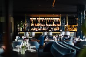 a restaurant with tables and chairs and a bar at 4K in Wangen im Allgäu