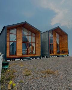 a house with two windows on top of a field at Tower Hill Cabin Dieng in Diyeng +3 photos