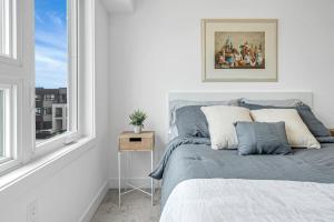 a bedroom with a bed and a window at Ritzy 3BR Home with Balcony Near Burlington Pier in Burlington
