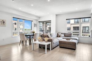 a living room with a couch and a table at Ritzy 3BR Home with Balcony Near Burlington Pier in Burlington
