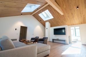 a living room with a couch and a tv at Villa Alpjuwel in Oberstdorf