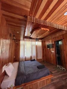 a bedroom with a bed in a wooden room at Byway, Kasol in Manīkaran