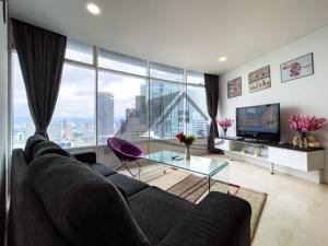 a living room with a couch and a large window at Vortex Residence KLCC ,12 Jalan Sultan Ismail Kuala Lumpur in Kuala Lumpur