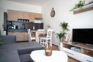a living room with a couch and a table at Apartmán Slunce in Poděbrady