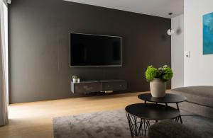 a living room with a flat screen tv on a wall at North Estate City House in Tromsø