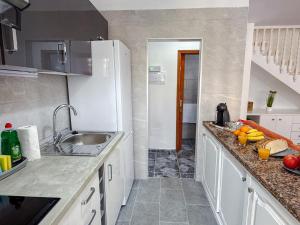 a kitchen with a sink and a counter top at El Delfín in Playa de las Americas