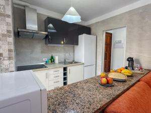 a kitchen with a counter top with fruits on it at El Delfín in Playa de las Americas