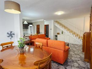 a living room with a couch and a table at El Delfín in Playa de las Americas +33 photos