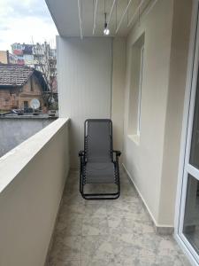 una sedia seduta sul balcone di un edificio di Luxury Apartment in Centre of Stara Zagora a Stara Zagora