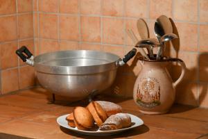 a plate of bread and a bowl and a plate of pastries at Agriturismo Il Poeta Contadino in Merine