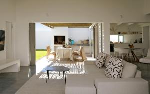 a living room with a couch and a table at The Cottage Collection Paternoster in Paternoster