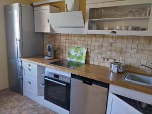 a kitchen with white cabinets and a stove top oven at Ferienwohnung Melba in Traben-Trarbach +18 photos