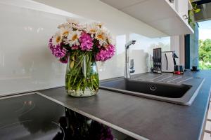 a vase filled with flowers sitting on a kitchen counter at VILLA MARE, ISTRA, relaxation, private pool, BBQ in Šegotići