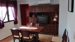 a dining room with a table and a tv at Apartamento Rural La Plaza Vieja in Viver