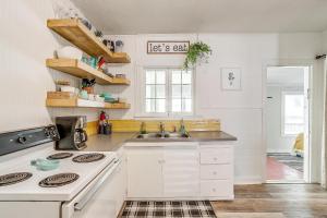 a white kitchen with a sink and a stove at Granbury Sunshine Shack - 2 Bedroom in Granbury