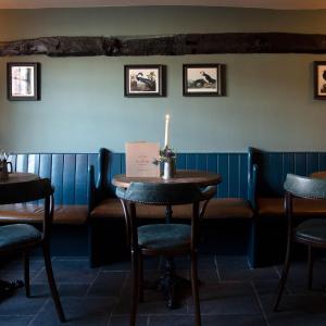 a dining room with a candle on a table at The Plume of Feathers in Farnham