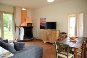 a living room with a table and a fireplace at Agriturismo Il Poeta Contadino in Merine +31 photos