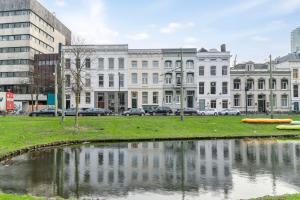 a body of water in a city with buildings at Central and light apartment in Rotterdam